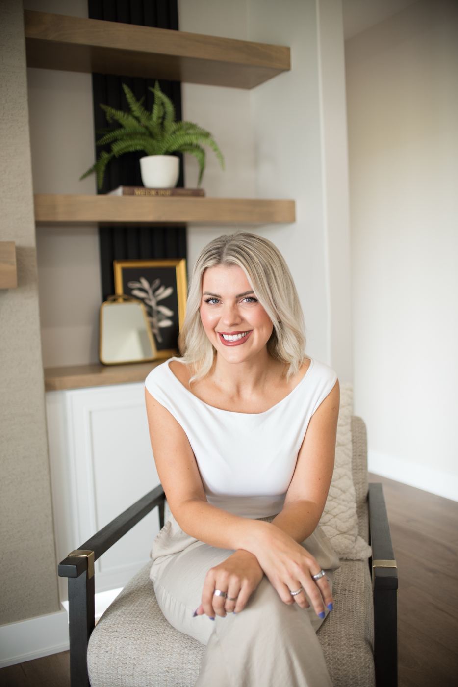 Portrait of Senada Agic seated in a styled living room